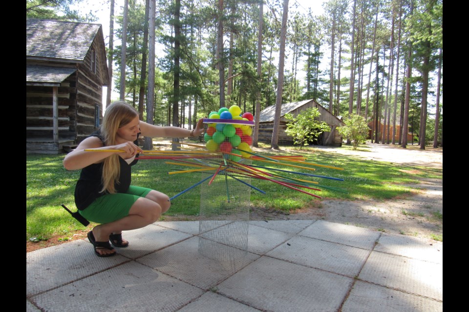 Meredith King plays full size Ker-Plunk. Photo by Shawn Gibson for BarrieToday. 