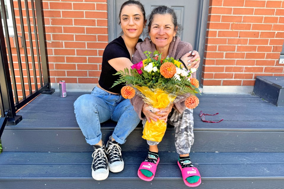 Monique Colls surprised her mother Teresita Fundora with flowers, just as a reporter happened by their house on Mother's Day.