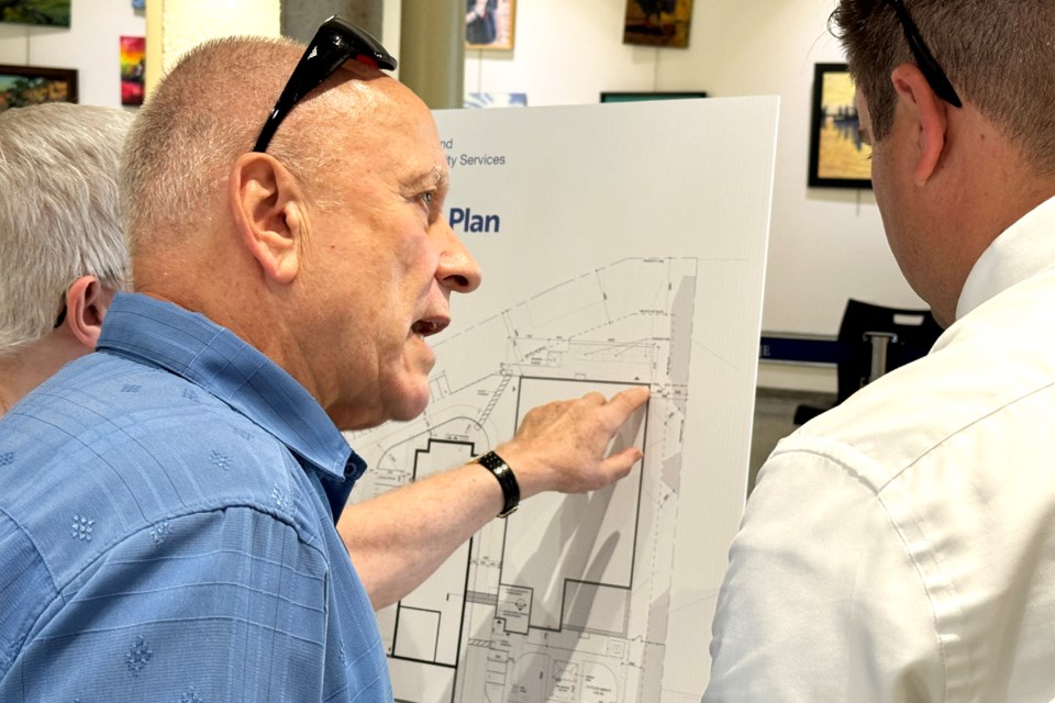 Henri Rohner questions a Simcoe County official at an information session at Barrie City Hall on Wednesday evening about a Rose Street social housing project that's in the works.