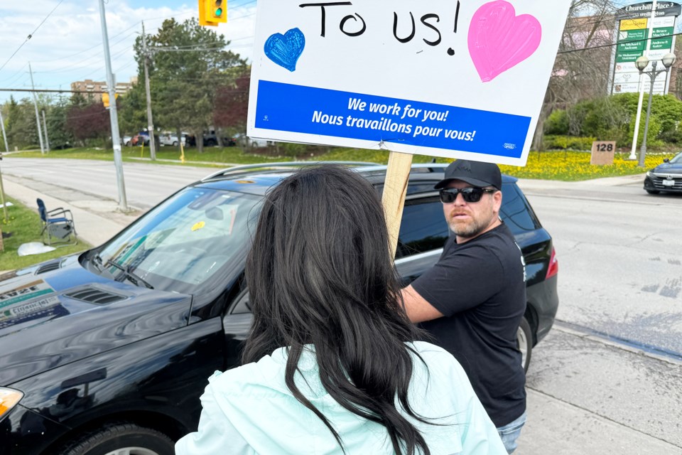 A man gets out of his vehicle and hurls insults at LifeLabs technicians, who are on strike for better wages and benefits, outside of the lab location on Wellington Street in Barrie on Monday, May 13. 