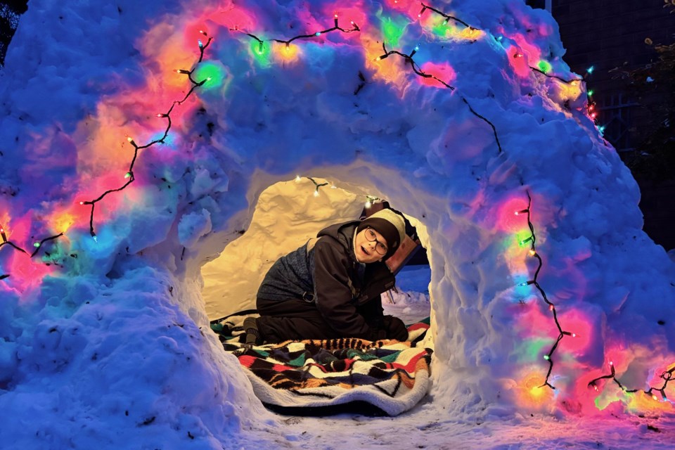 George Bedard, 10, of Barrie, enjoys his snow house he constructed at his home near Hurst Drive.