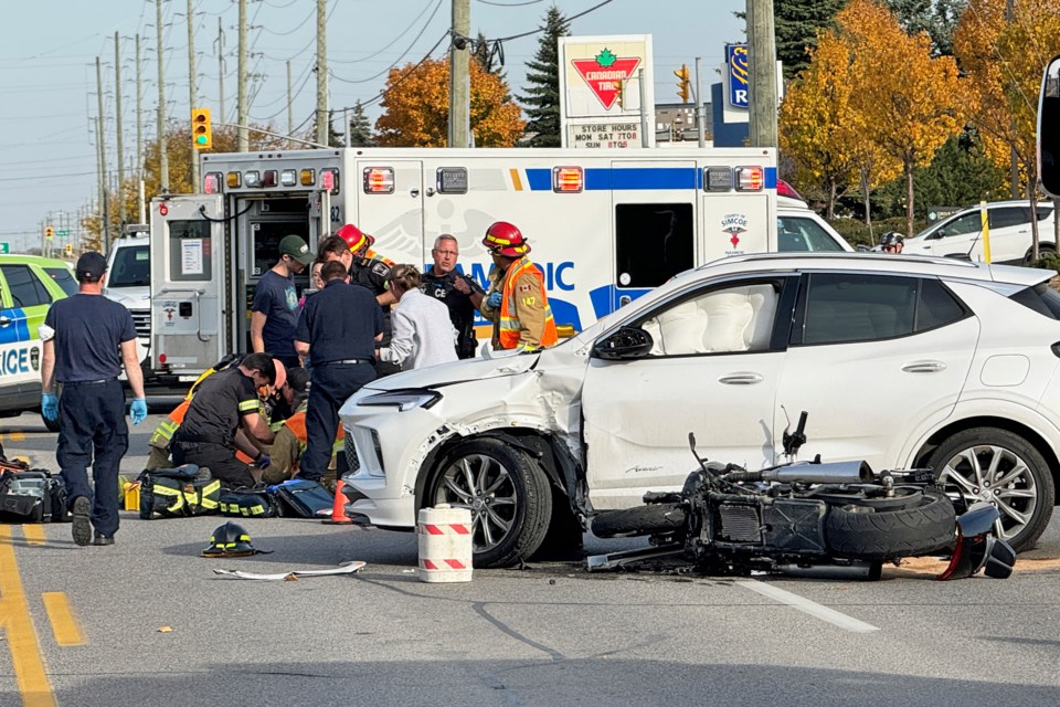 Emergency crews tend to a driver at the scene of a serious motorcycle crash on Mapleview Drive West on Tuesday afternoon.