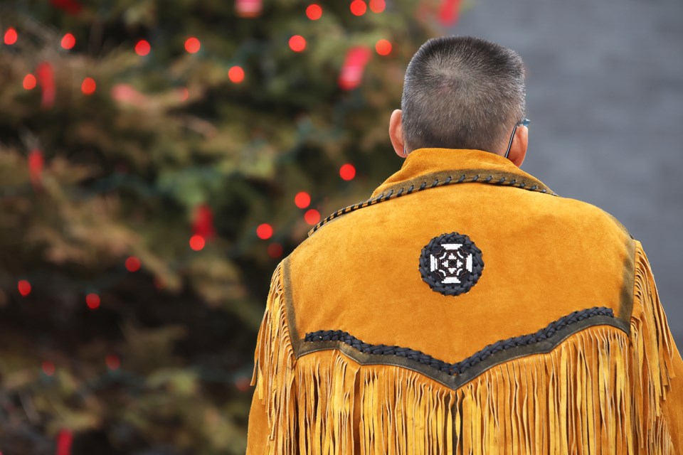 Visitors watch a tree lighting at police headquarters on Fairview Road on Sunday. The Barrie Police Service hosts the Tree of Hope campaign to bring awareness to the missing and murdered Indigenous women, girls, two-spirit and gender-diverse people across Canada.