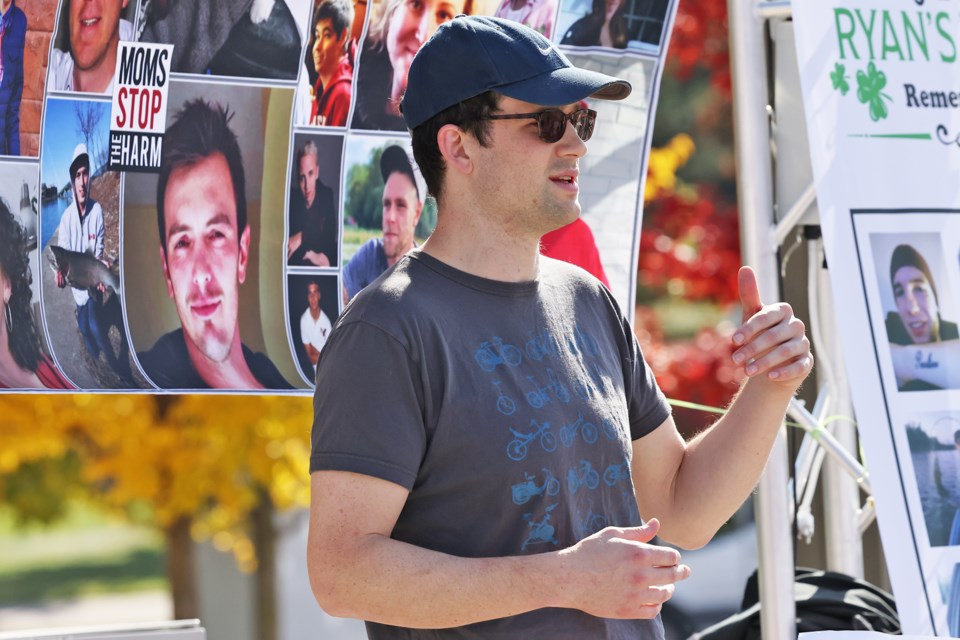 Dr. Mac Chown, who formerly worked as a doctor in the emergency department at Orillia Soldiers' Memorial Hospital, speaks to people gathered for a die-in protest in support of supervised consumption sites in the province, which are being shut down by the government, at Memorial Square in Barrie on Monday.