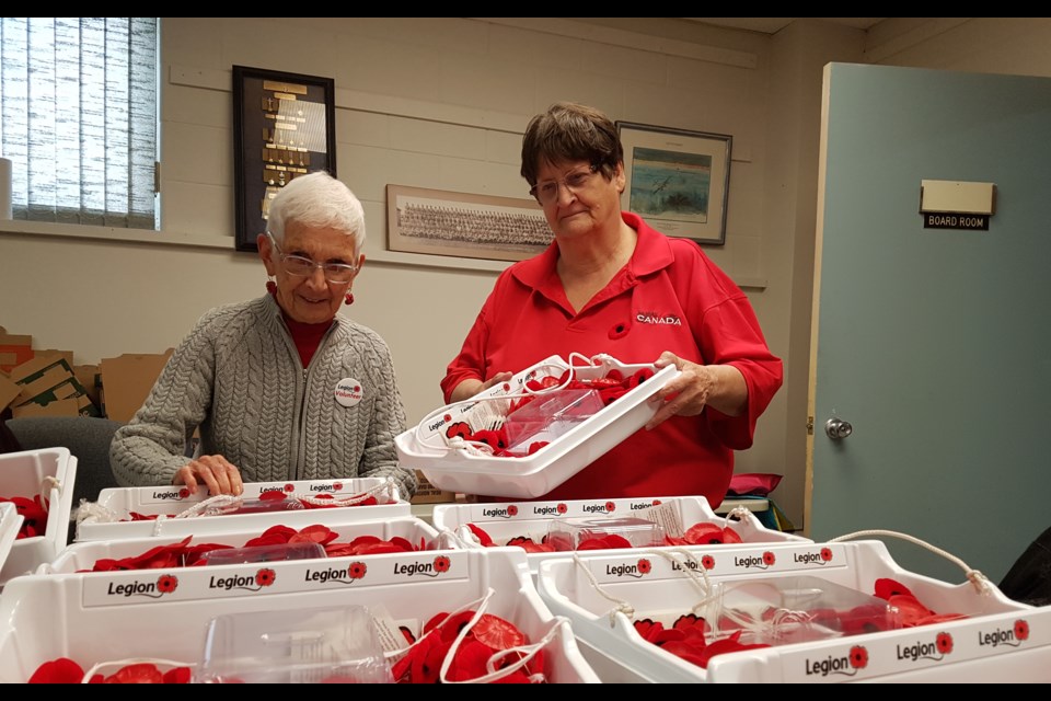 Joan Archer, left, and Sharon Gordon get busy sorting the thousands of poppies that will be distributed throughout the city until Remembrance Day, Friday Nov. 1, 2019. Shawn Gibson/BarrieToday