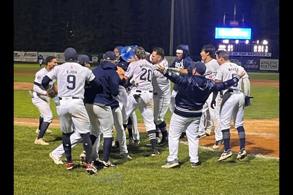 The Barrie Baycats rush home plate following Adam Odd's walk-off home run against Guelph on Sunday night. The Baycats hosted the Guelph Royals in Game 1 of the Intercounty Baseball League playoffs on Sunday night at Vintage Throne Stadium. The Baycats won, 12-10, in extra-innings.