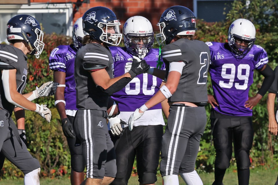 The St. Joan of Arc Knights celebrate after a touchdown against the St. Peter's Panthers on the Knights' home field on Thursday. The final score was 55-0 for St. Joan of Arc.