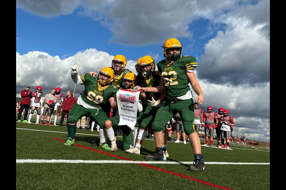 Captains from the Barrie North Vikings senior football team hold the championship banner after winning the Simcoe County Athletics Association (SCAA) title on Friday, Nov. 8, 2024. 