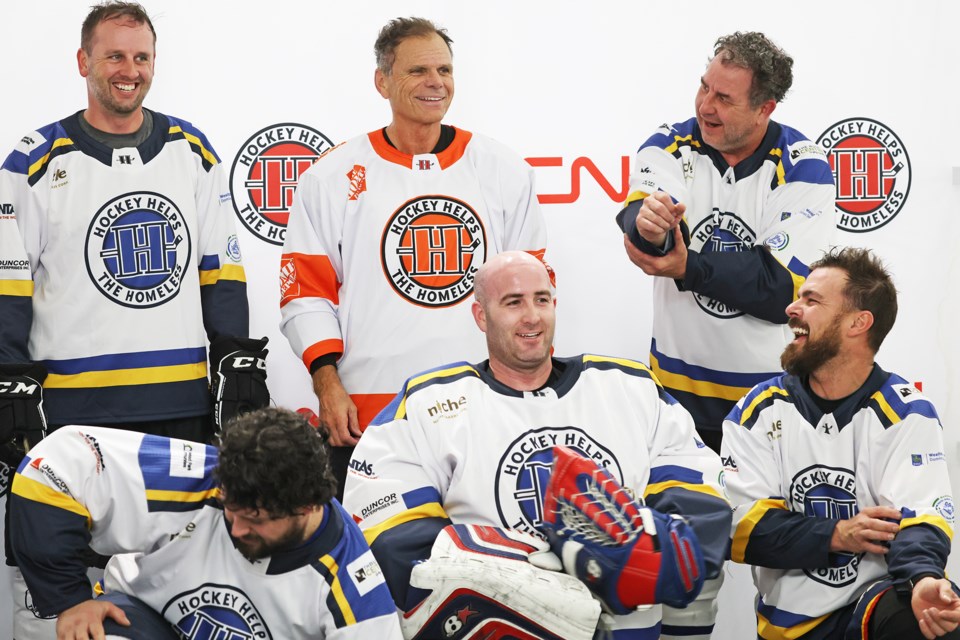 NHL Hall of Famer Mike Gartner shares a laugh with players during the Hockey Helps the Homeless fundraising tournament at Peggy Hill Team Community Centre on Mapleton Avenue in Barrie on Friday.