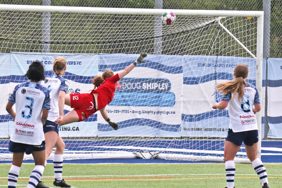 Simcoe County Rovers goaltender Alicia Chisholm tries to make the save, but the Woodbridge Strikers scored to make it 2-0 at the half on May 11 at J.C. Massie Field at Georgian College in Barrie.