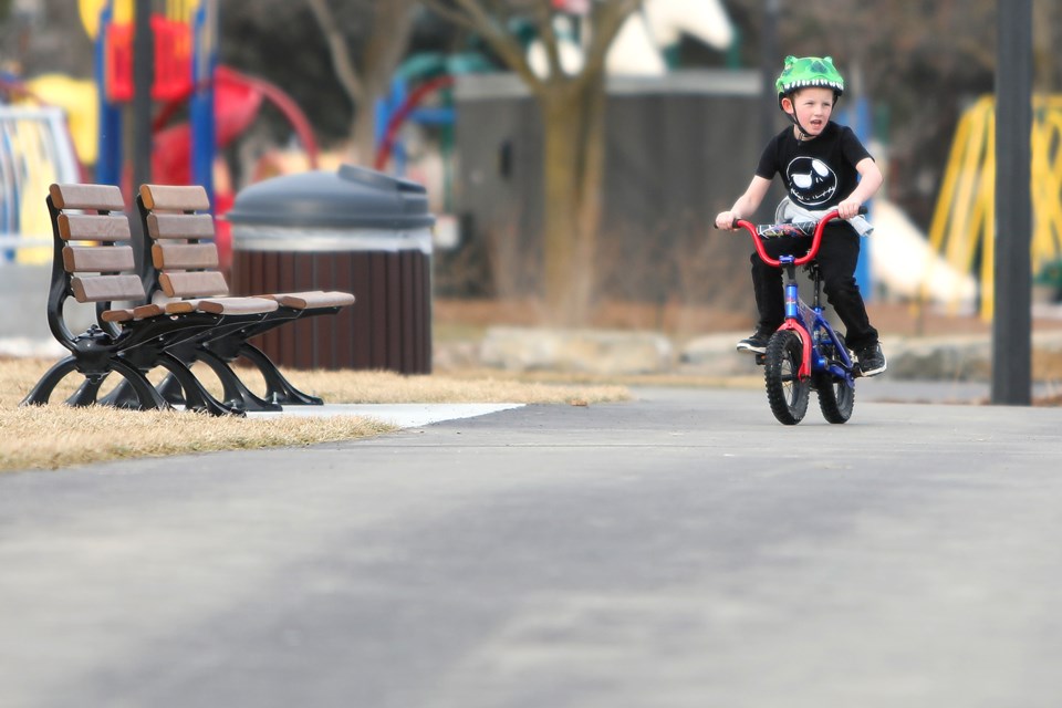 A young rider watches people out on the ice as he enjoys the seemingly balmy weather in Barrie as temperatures rose to 8 degrees along the lakeshore on Saturday, Jan. 27, 2018.  Kevin Lamb for BarrieToday.