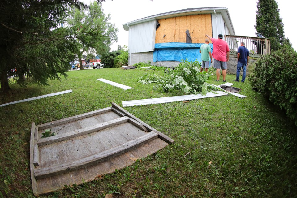 Ian Hendley points to a spot on his home on 2 Somerset Boulevard after a tornado lifted part of the house off its foundation when it struck a residential area in Oro Station last night. Kevin Lamb for BarrieToday