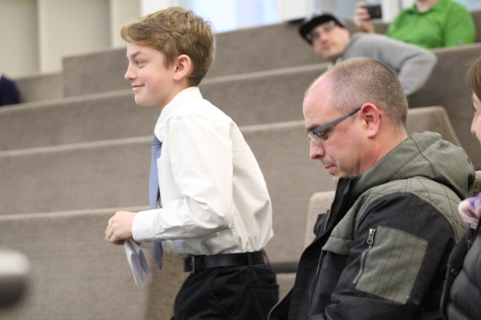 Liam Surka returns to his seat in the council chambers at city hall after reading his contest-winning 'Why I Love Barrie' essay to city councillors and staff. Raymond Bowe/BarrieToday