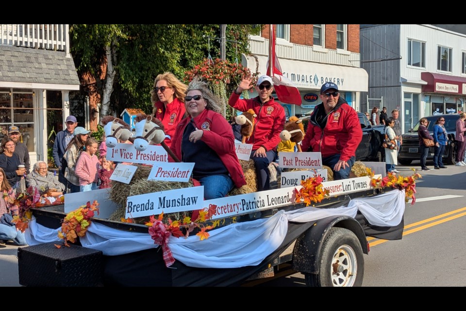 The executive team of the Elmvale Fall Fair wave to spectators during the parade Friday morning.