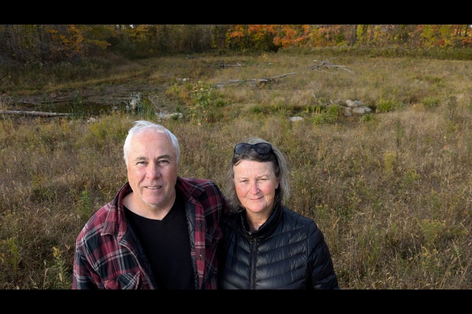 Steve and Nancy Astin stand in front of the wetland they created on their farm in Oro-Medonte Township. The efforts led to the duo receiving a Healthy Land award from the Lake Simcoe Region Conservation Authority.