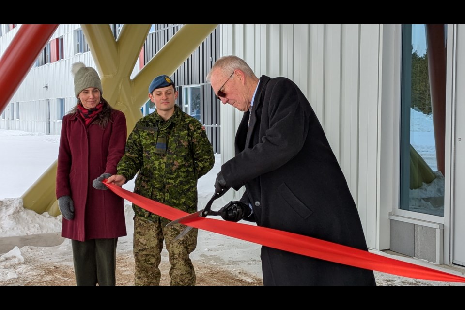 Defence Minister Bill Blair cuts the ribbon to officially open the Cambra Accommodation Building at CFB Borden on Thursday morning.