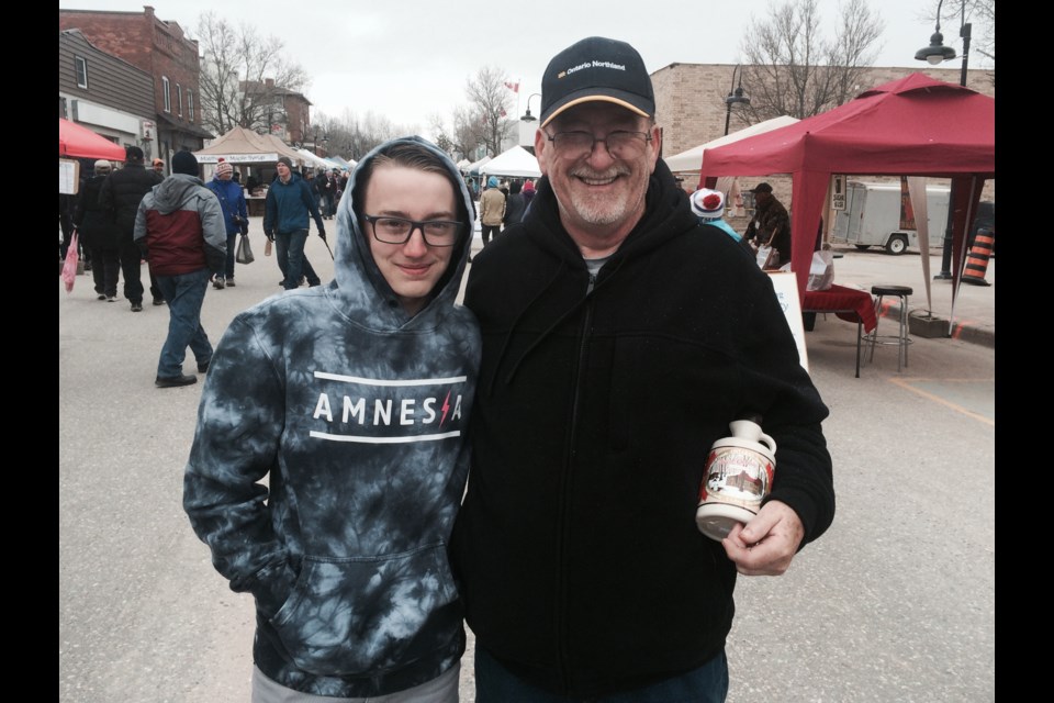 Mason Mills and grandpa Bob replenish their maple syrup supply at the 21st Annual Powassan Maple Syrup Festival