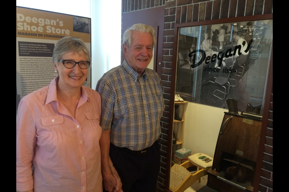 Pat and Ralph Diegel stand in front of a replica of their storefront as part of the Main Street, North Bay exhibit at the North Bay Museum