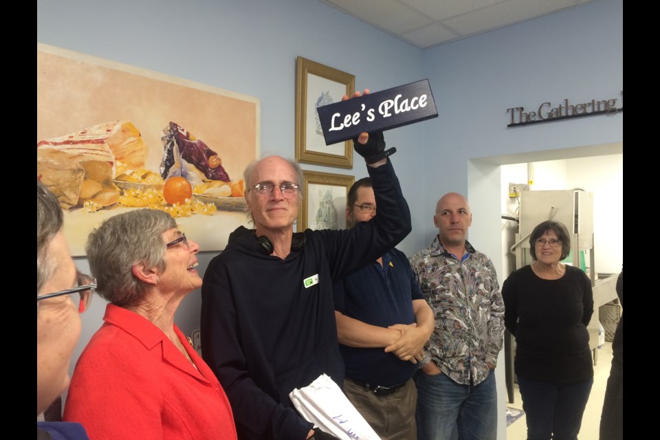 Long time volunteer and honourary fundraising chair Lee Dreany proudly displays the plaque bearing his name to be placed above the new outreach office at The Gathering Place