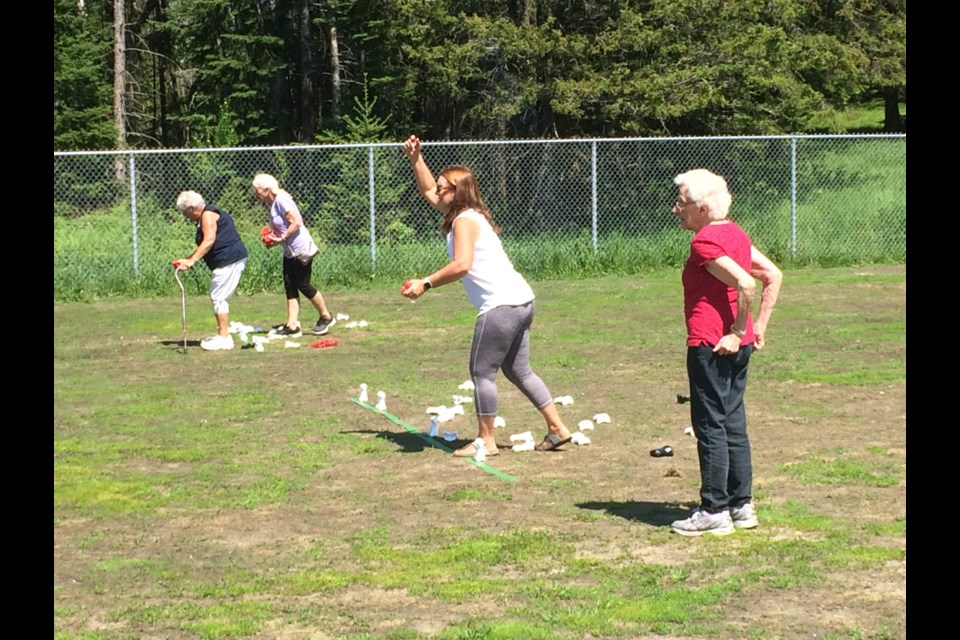 Terri Moore (throwing) and Jeanne Knight team up for a game on "Bones" at the East Ferris 50+ Senior Games