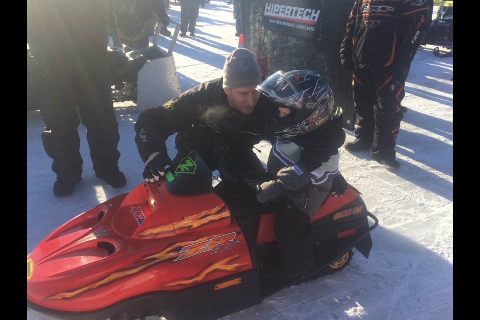 Four-year-old Remmy Levasseur listens while dad Cody gives him some instruction before heading down the track at the NBSSR competition