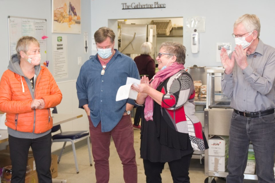 Sylvia Antinozzi happily receives a donation from Maureen Brazeau of Rebuilt Resources to help with this year's Christmas Dinner. (Left to right) Maureen Brazeau, Dennis Chippa, Sylvia Antinozzi, Robert Cunningham /Photo David Briggs 