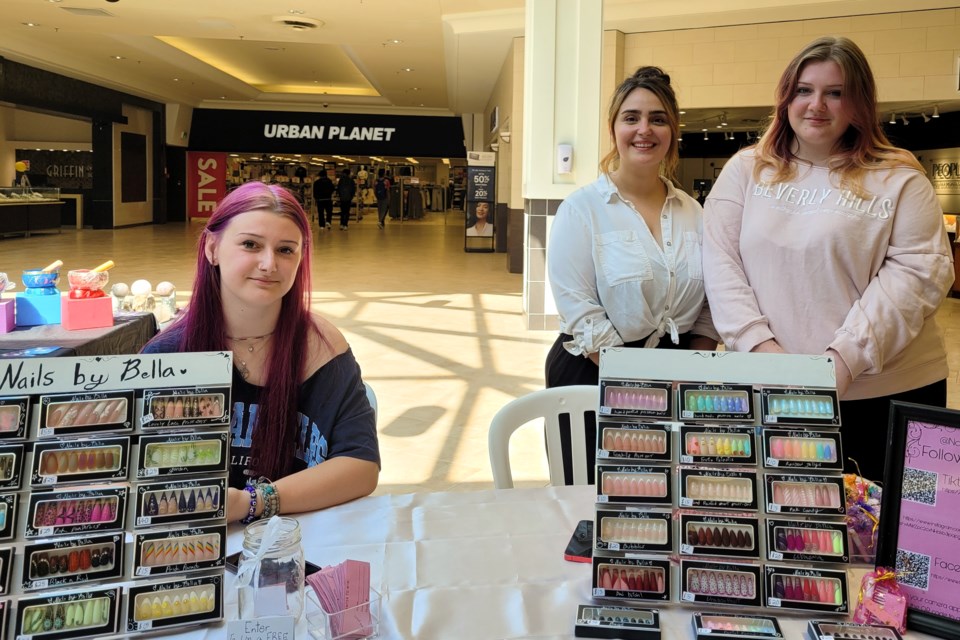 Marketing and Youth Programming Director for the Business Centre, Sarah White (middle) stands beside Izabella Hammill, founder of Nails by Bella. Izabella's sister, Sophie (left) came out to support the cause, and model the product