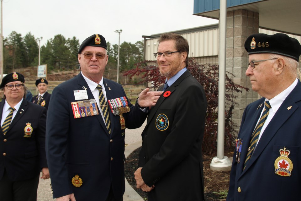 Legion Branch 445's President Richard Rhindress presents Callander's mayor Robb Noon with the first poppy of this year's poppy campaign