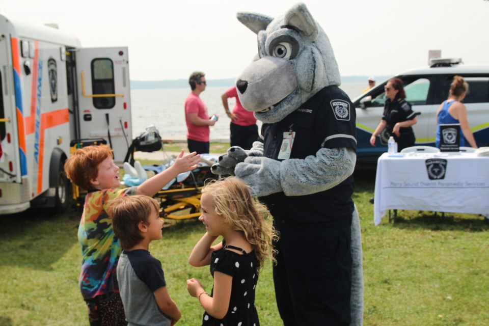 Three little safety fans get to meet and have a chat with a very special paramedic dog at last year's event