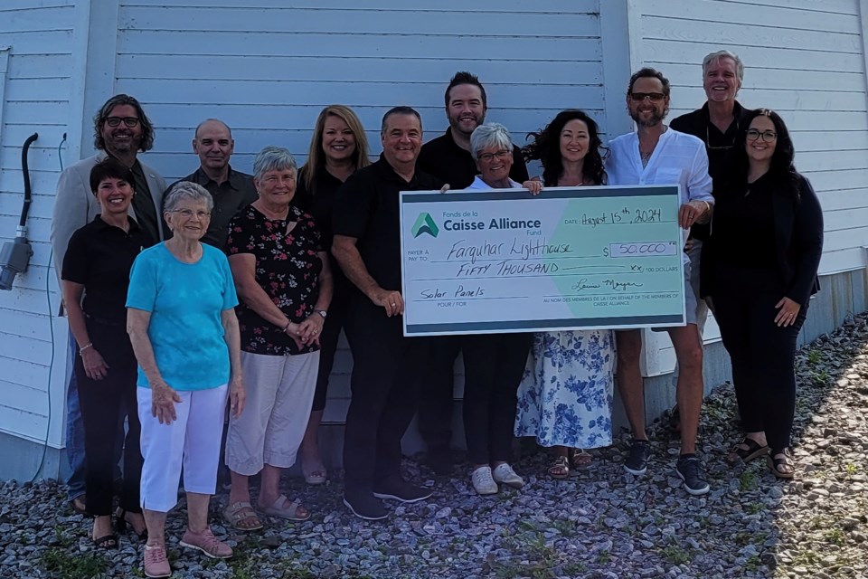 Members of Caisse Alliance paid a visit to Farquhar Island Lighthouse to present Ryan and Erin Farquhar with a $50,000 cheque to go towards installing solar panels at the light house