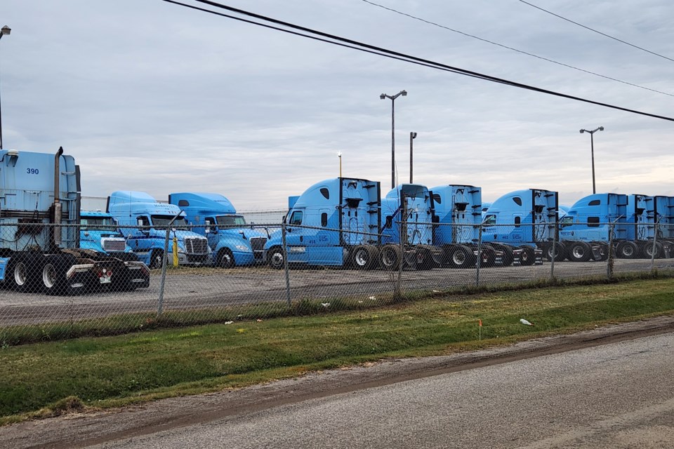 Dozens of tractors and trailers are idled at McKevitt Trucking's Thunder Bay headquarters (TBnewswatch photo)