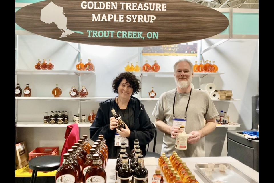 Melanie Murphy and her husband Harry Kessels promoting their business Golden Treasure Maple Syrup at the Northern Ontario Pavilion at the Royal Agricultural Winter Fair.