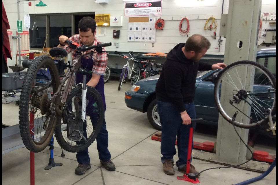 Since 2015, volunteers with Discovery Routes’ ReCycle Bikes Program have tuned up and distributed over 60 children and youth bicycles. The volunteers in the photo are Tim Clayton (left) and Pierre Mayotte. Supplied.