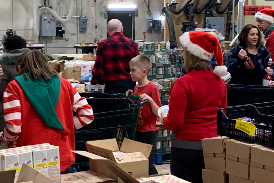 Packing for the Santa Fund at Canadore College Commerce Court Campus Dec. 22, 2022.  File photo by Chris Dawson/BayToday. 