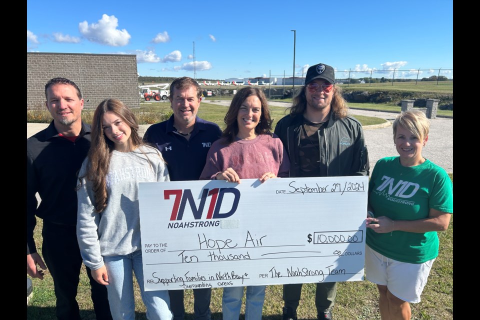 Noah Strong officials Jody Dugas, Jorja Dugas, Glen Gravelle, Dave Dugas, Kelly Turcotte and musician Cory Marks at Jack Garland Airport for Hope Air funding announcement. 