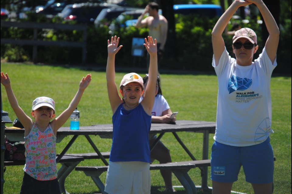 Walk for Alzheimer's participants limber up with a warm-up led by Ohana Wellness Sunday at the Kiwanis Bandshell. Photo by Stu Campaigne.