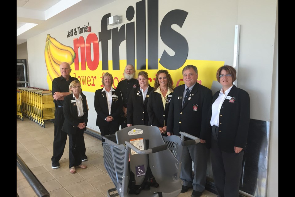 Local Elks Club Members along with National President Denis Ellingboe, show off the new Caroline's Cart they are donating to No Frills on Lakeshore Drive.  Photo by Chris Dawson. 