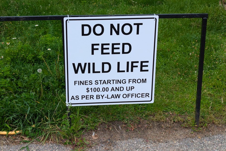 A sign posted at Waters Edge Care Community warning about the fines for feeding pigeons.