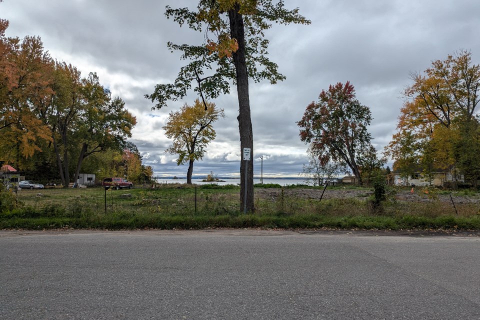 The view from Sunset Boulevard of the site of the proposed tiny home development, with Lake Nipissing in the background.