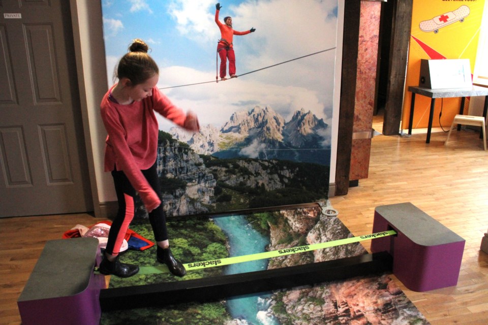 A young student tries out the slack line at Discovery Museum as part of the Beyond Human Limits exhibit. Photo by Chris Dawson/BayToday.ca. 