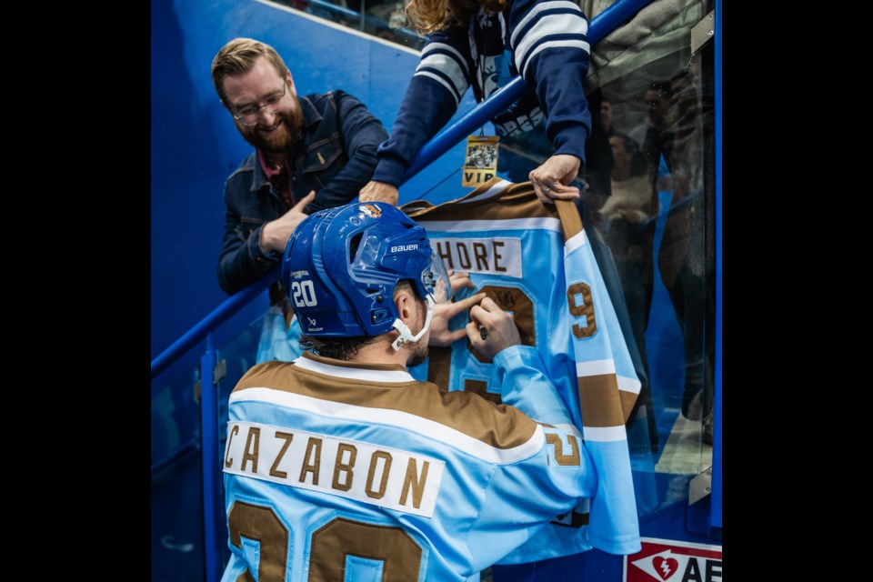 Bourke Cazabon signs a Shoresy jersey for a fan during the Shoresy Classic Alumni Tour. 