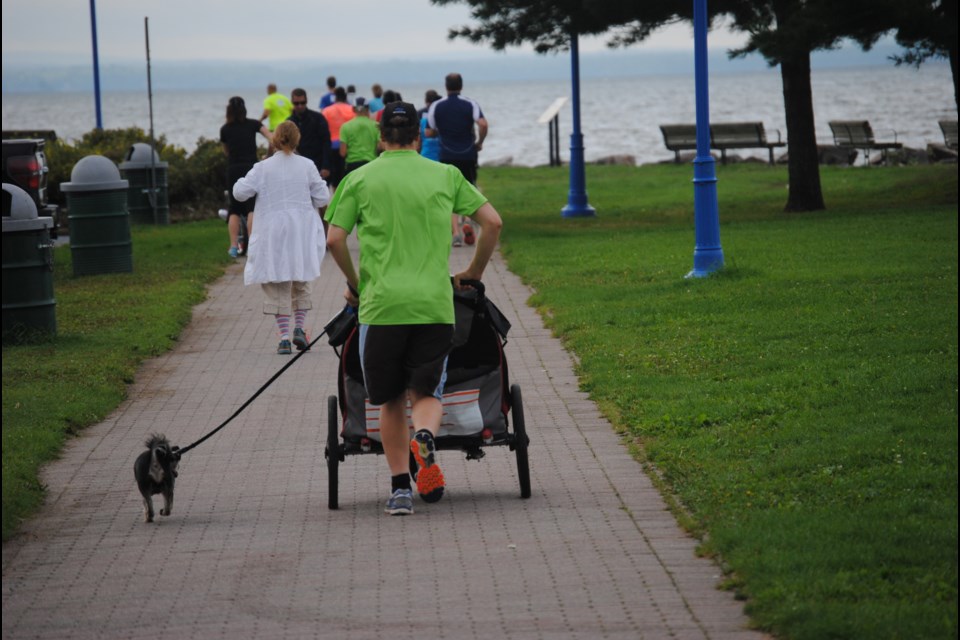 Puppy love of another kind? This man pushed two children in a stroller with the guidance of his canine friend