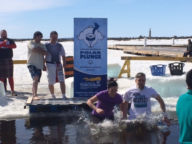 Chris Thorne takes a dip in Lake Nipissing as part of the Special Olympics annual Polar Plunge. Photo by Dennis Chippa. 