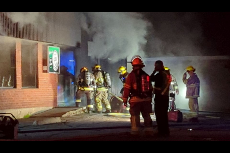 Firefighters enter the restaurant. 