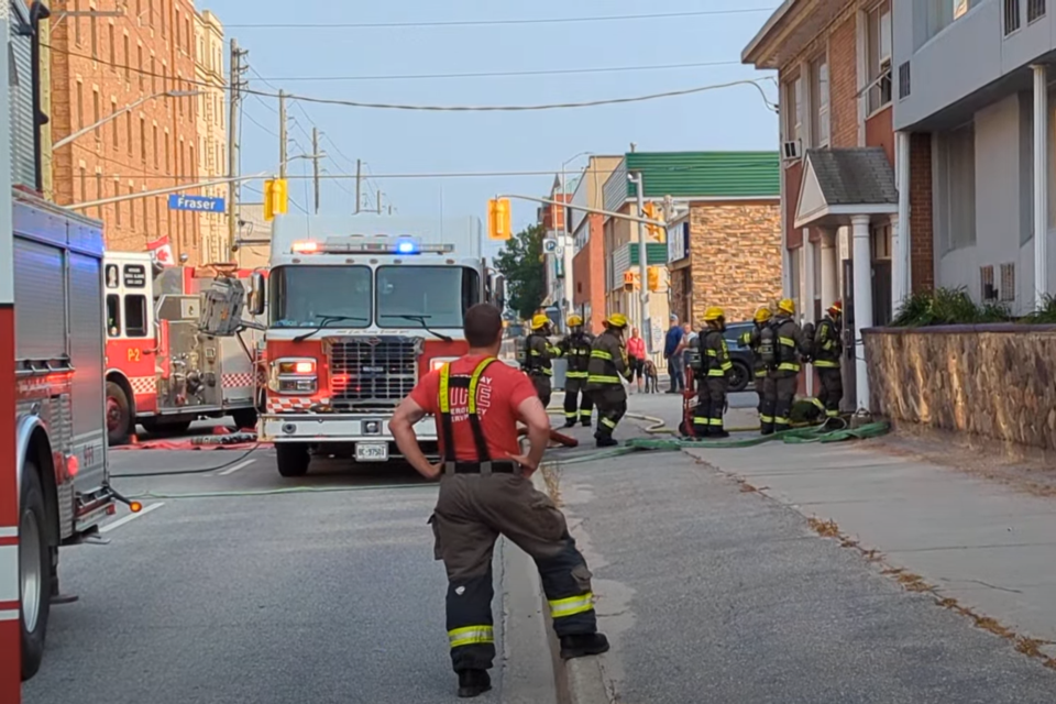 Firefighters prepare to enter and sweep 225 McIntyre St. W.