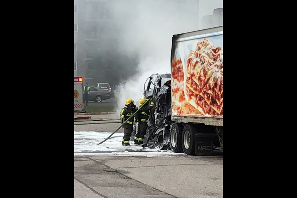 A crew fights a truck fire on Trout Lake Road this afternoon.