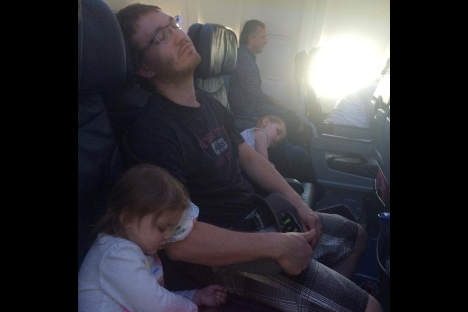 A dehydrated, hungry and exhausted family flies back to Ontario after escaping the flames of Fort McMurray. Photo courtesy Tara Clair.