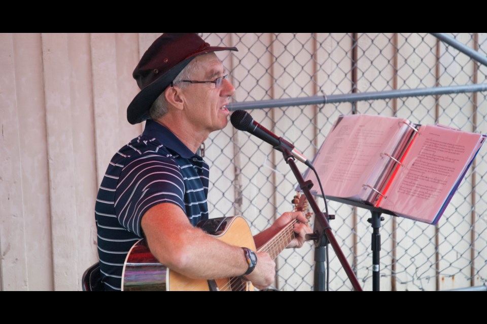 Former lawyer for the City of North Bay Mike Burke played the guitar and sang tunes with the pattering of rain to accompany him.