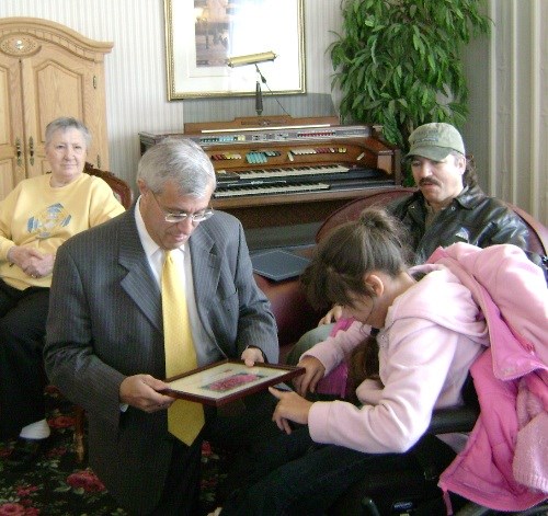 Easter Seals Ambassador Talia Moore presents Mayor Vicwith the official Easter Seals stamp