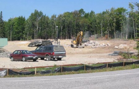 Construction crews are busy clearing ground for the new Nipissing University residence that will be next door to some uneasy Cedar Heights homeowners.  Photo by Bill Walton.